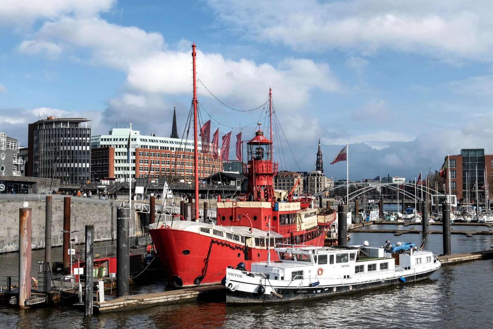Ships in Hamburg harbour beside waterfront buildings