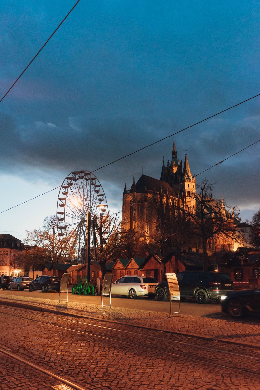 Erfurt cathedral square with an illuminated Ferris wheel in the evening
