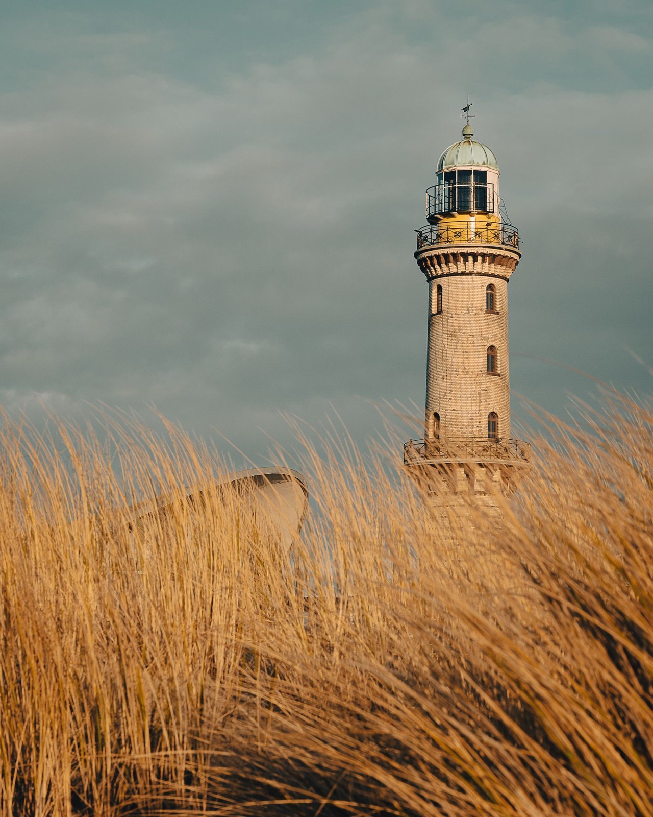 Warnemünde lighthouse behind beach grass