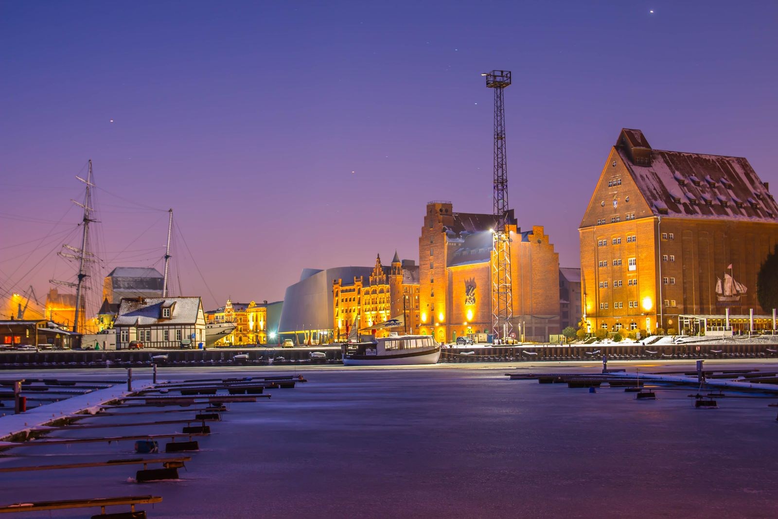 Illuminated buildings beside Stralsund harbour in winter