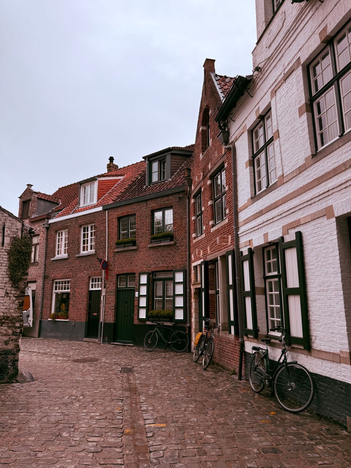 Cobbled street with brick buildings in Bruges