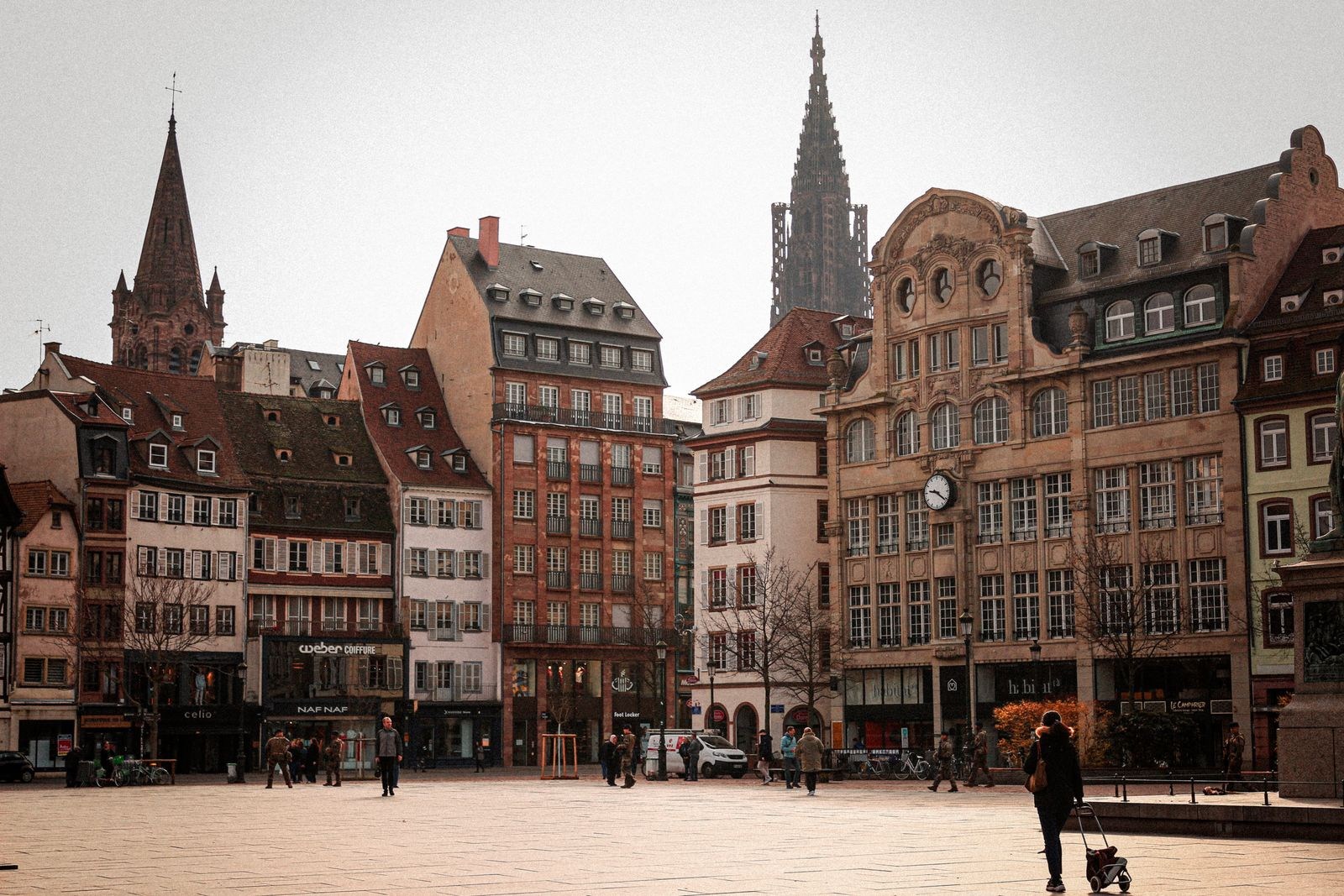 Square with historic buildings and church spires in Strasbourg