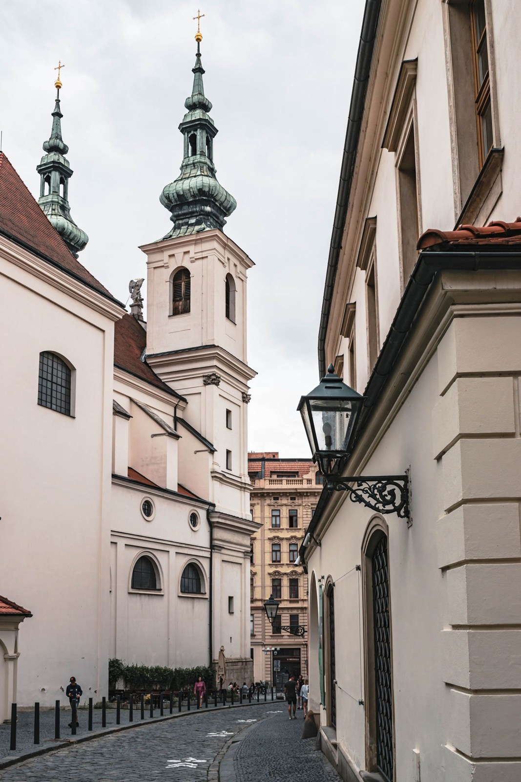 Narrow street with church towers in Brno