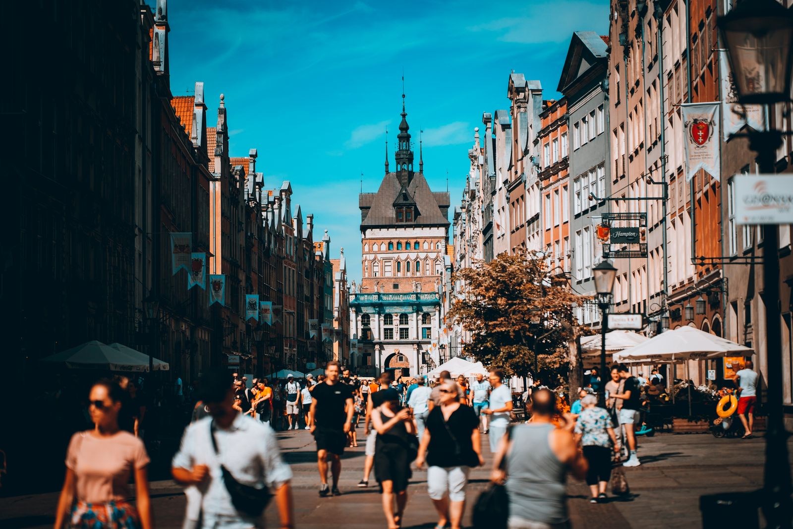 Busy street lined with historic facades in Gdańsk