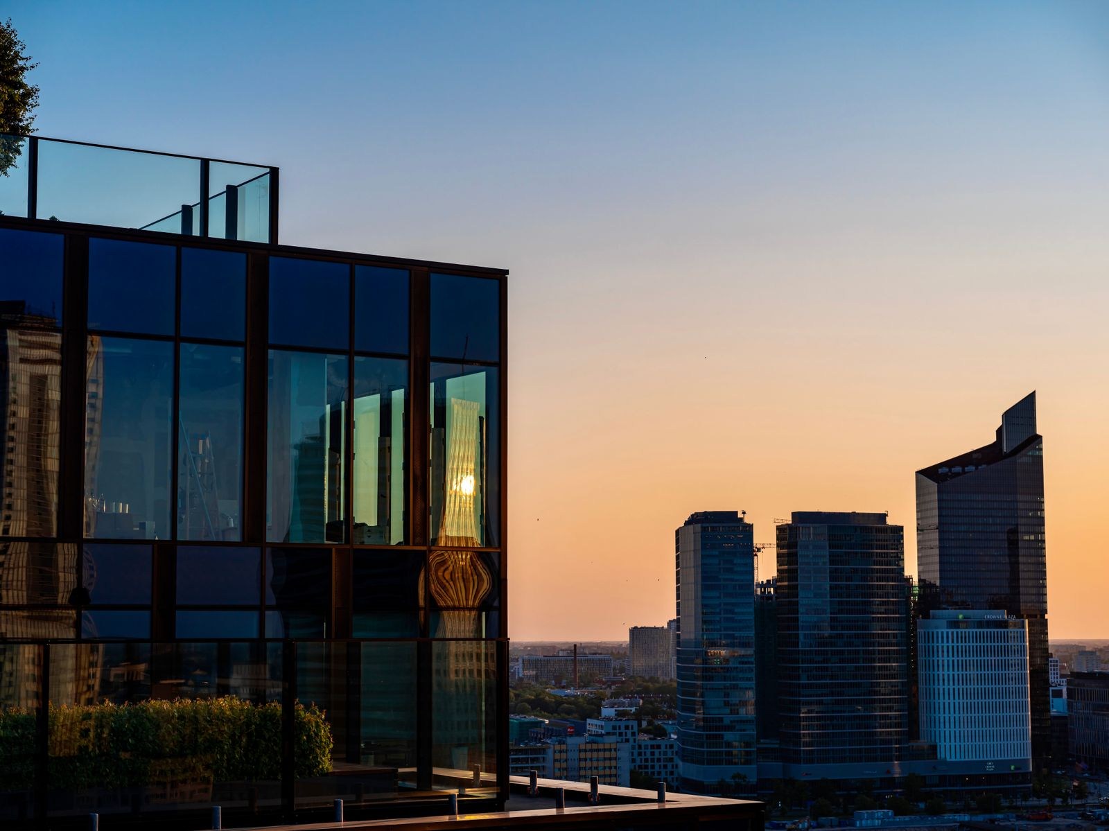 Warsaw high-rises and glass facades at sunset