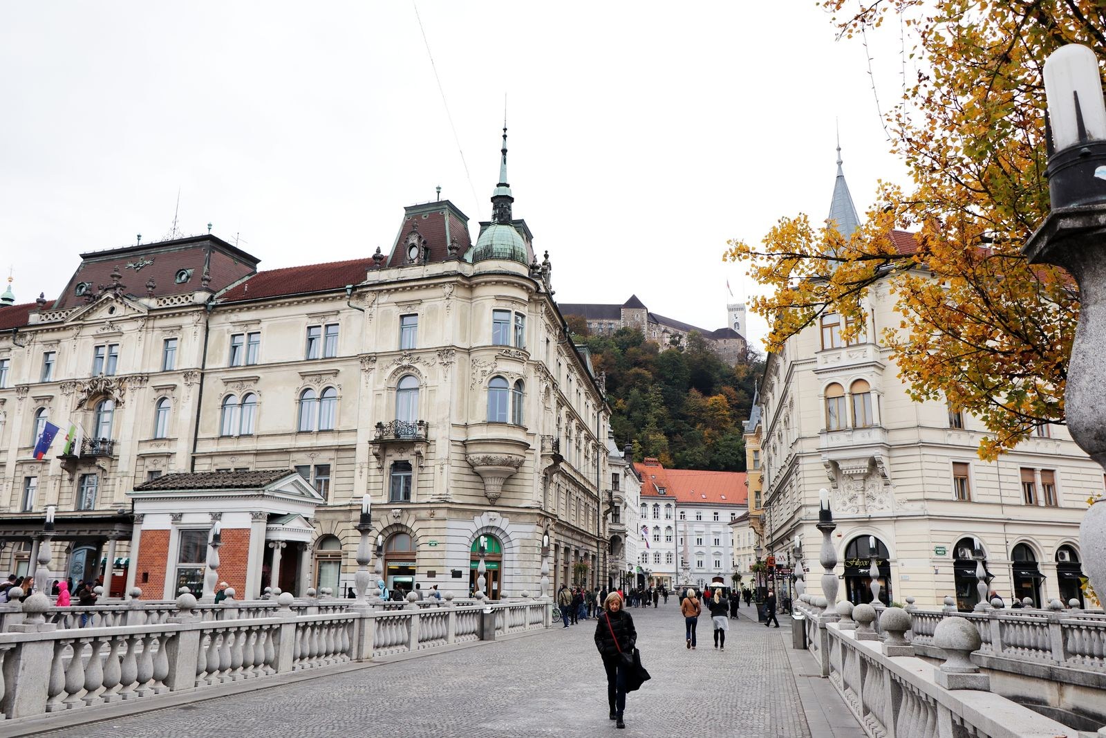 Bridge with pedestrians and historic buildings in Ljubljana