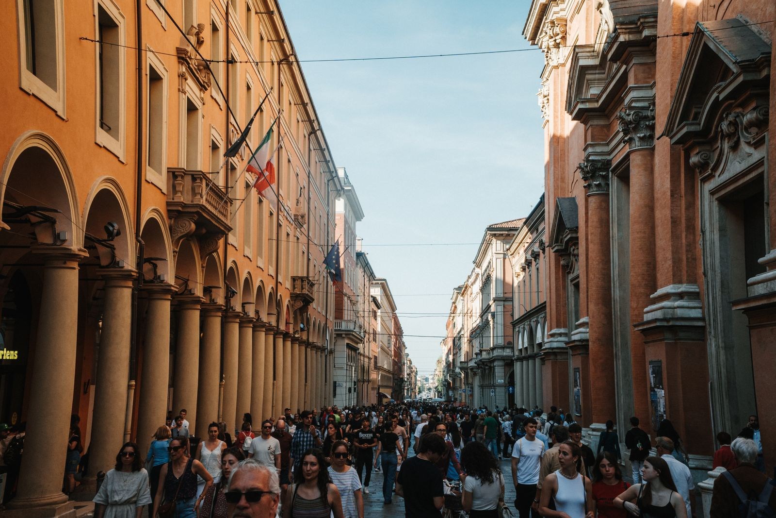 Busy street with porticoes in Bologna