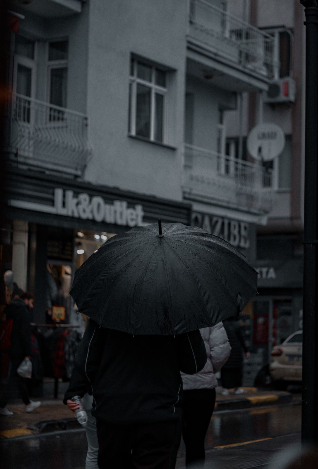 Pedestrian with umbrella on a wet city street