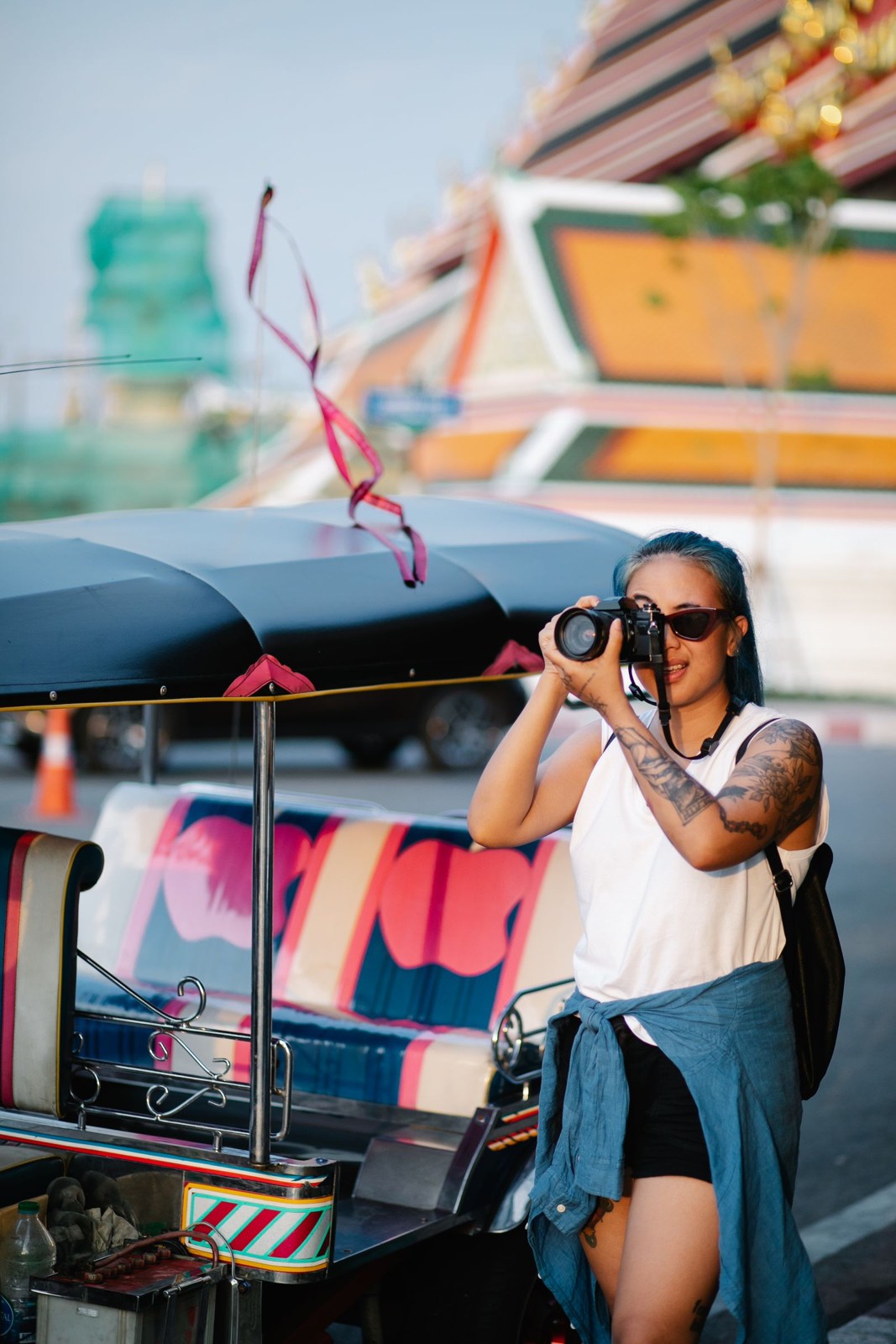 Traveler taking a photograph with a camera on a city street