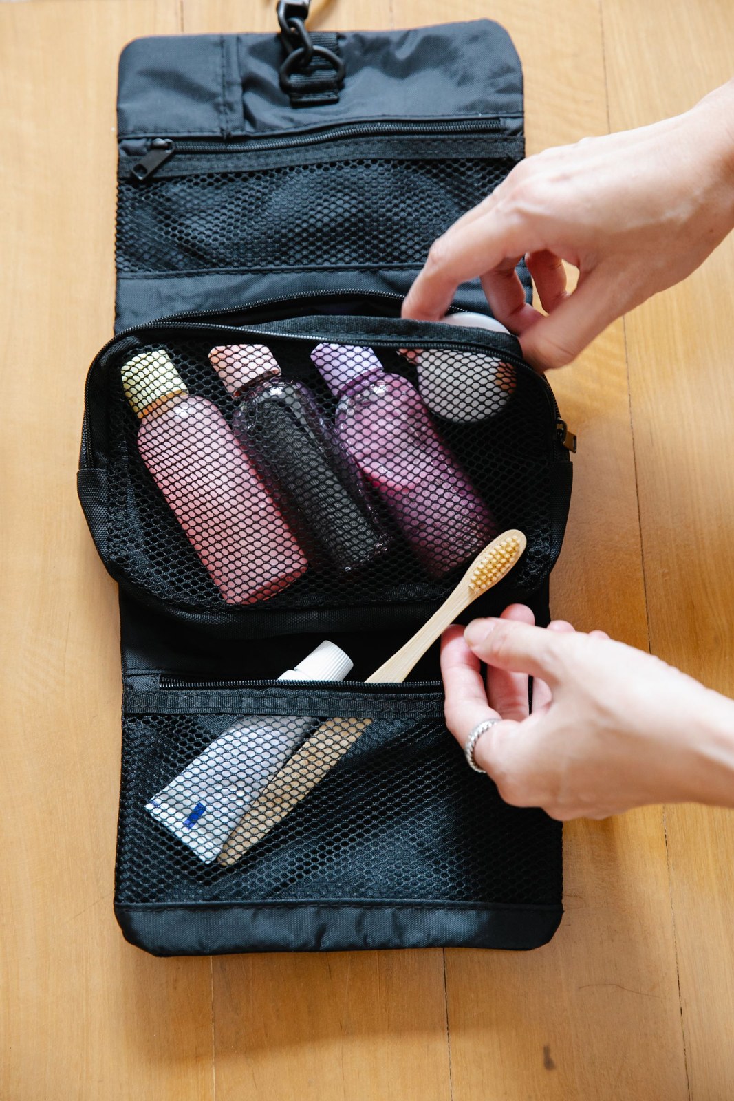 Open wash bag with bottles and toothbrush