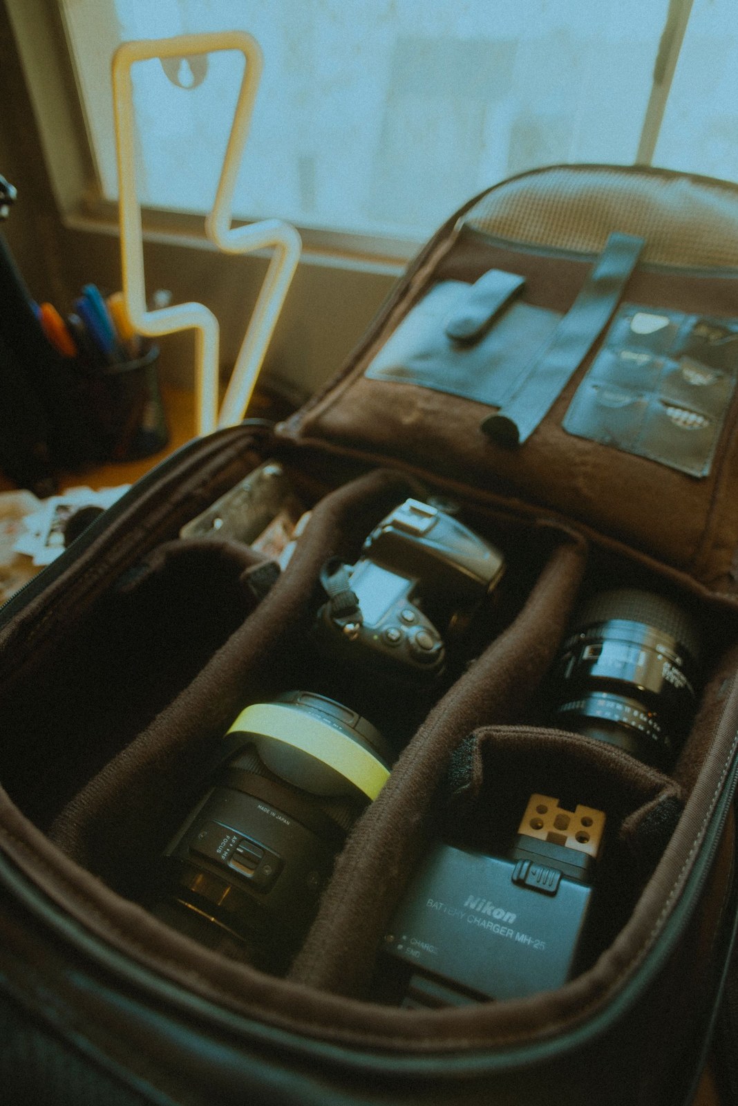 Camera equipment organised inside a padded bag
