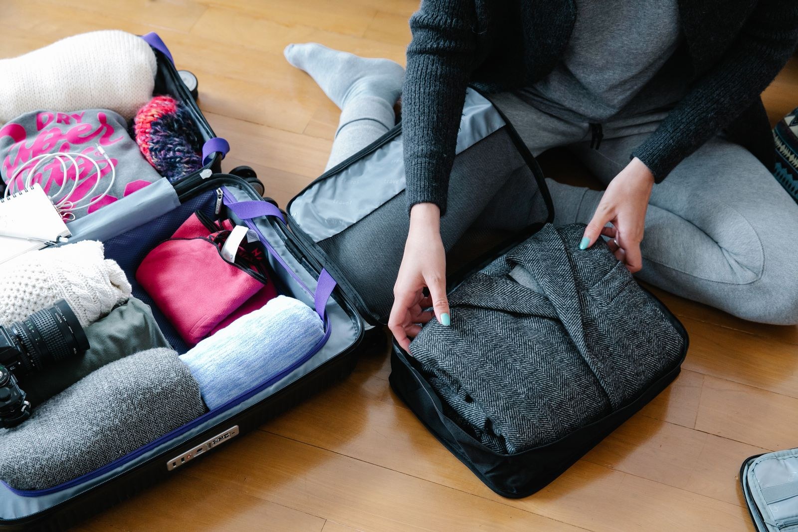 Traveler arranging clothes and equipment before packing