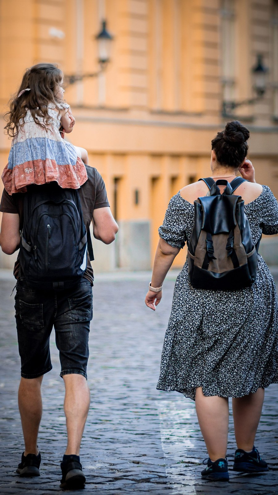 Family with a child on a cobbled city street