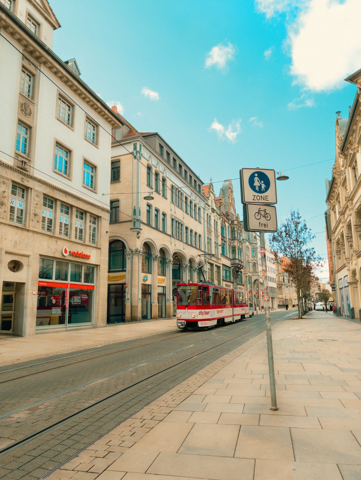 Tram and stop between city buildings